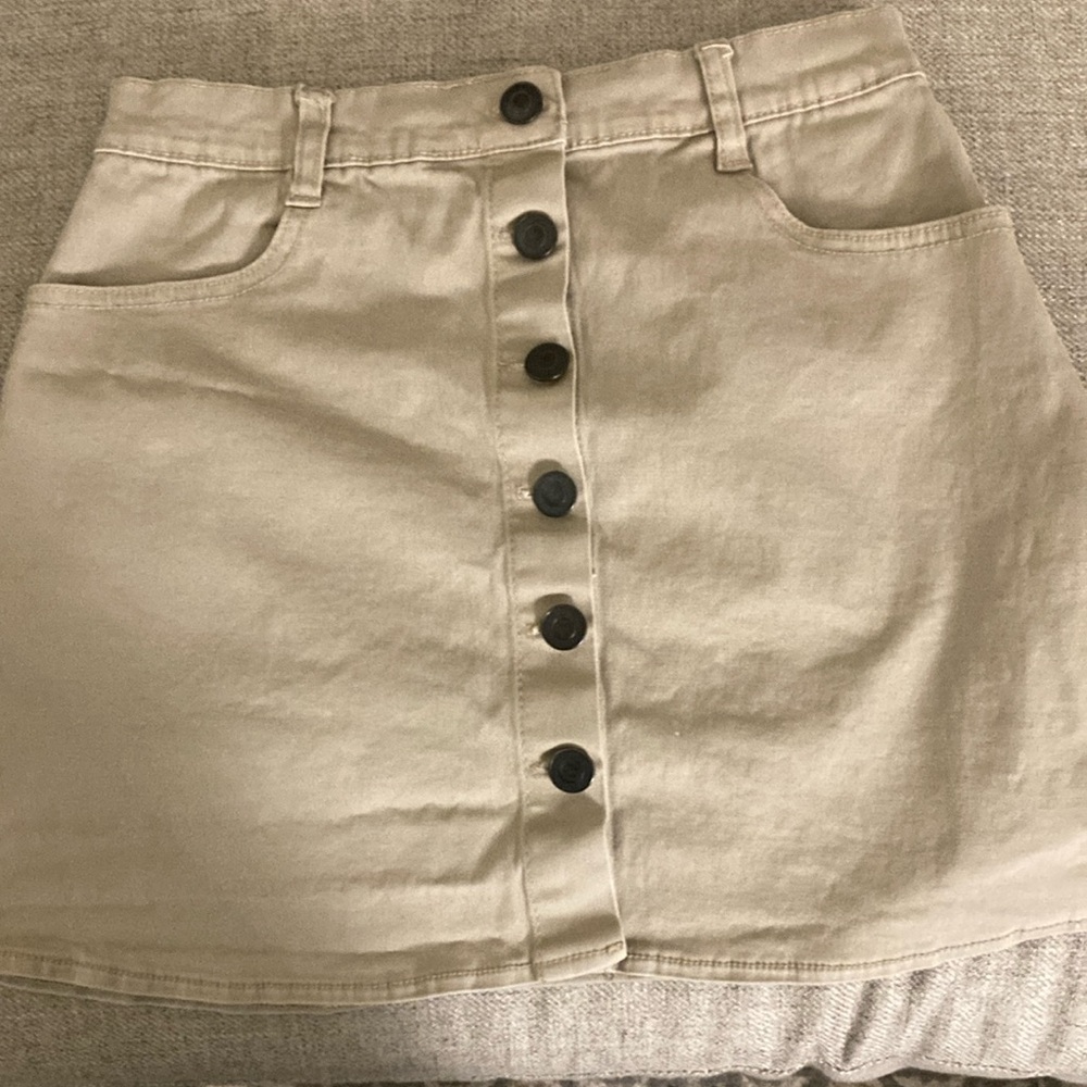 Tan skirt from brandy Melville with buttons.